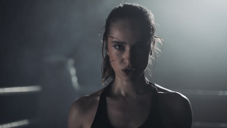 intense portrait of a sweating female boxer