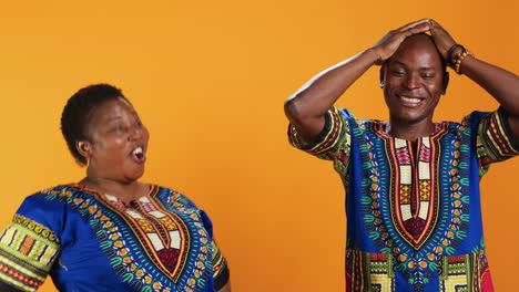 joyful african american people laughing at something in studio