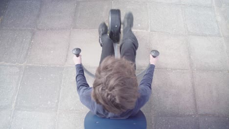 Top-down-view-of-a-man-exercising-on-an-exercise-bike-outdoors