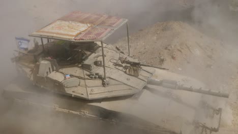 israeli combat vehicle tanker merkava driving through concrete rubble and dust remains of gaza in war between israel and hamas