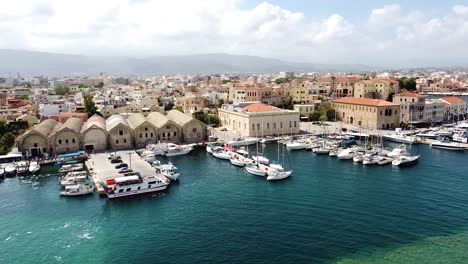 cinematic aerial view of chania city pier and downtown