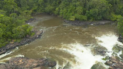 drone shot looking over a river waterfall in the jungles of guyana