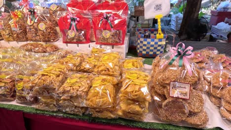 assorted snacks displayed at a vibrant market stall