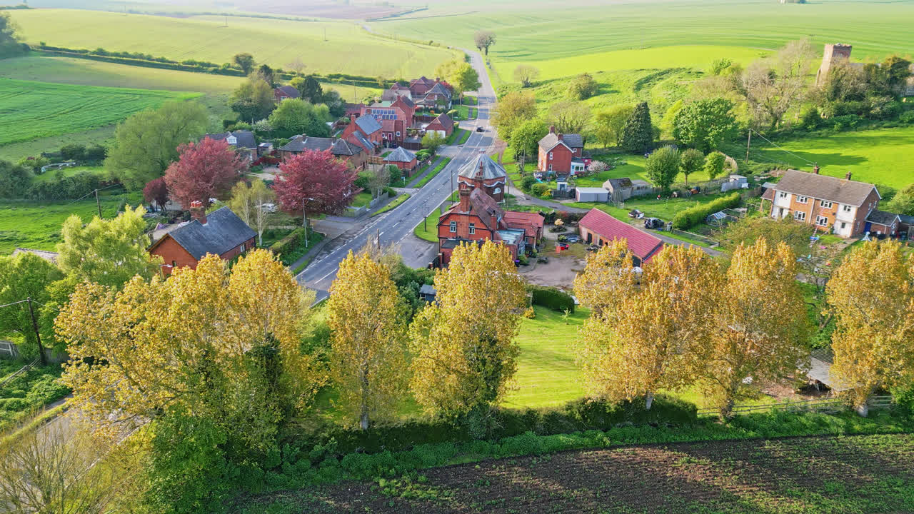 Aerial drone view portrays Burwell village, once medieval market town&mdash;country fields, vintage red brick homes, and the idle Saint Michael parish church on Lincolnshire's Wold Hills