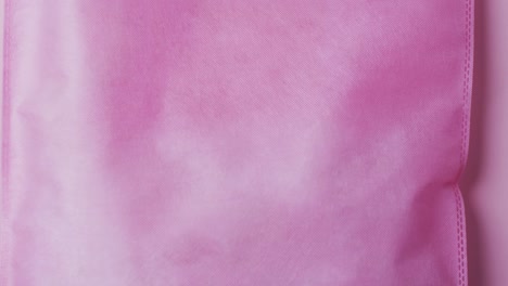 video of pink canvas bag with copy space on pink background
