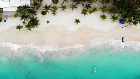 flying drone in roatan beach with crystal clear blue water