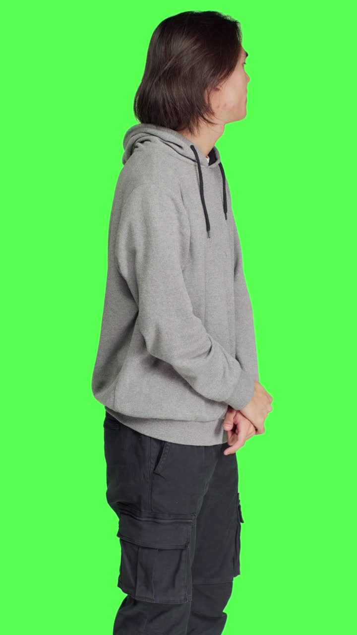 Side view of dissatisfied guy in studio awaiting