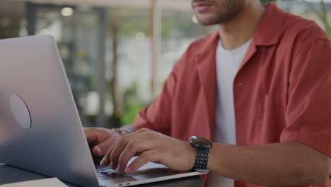freelancer working on laptop in street cafe