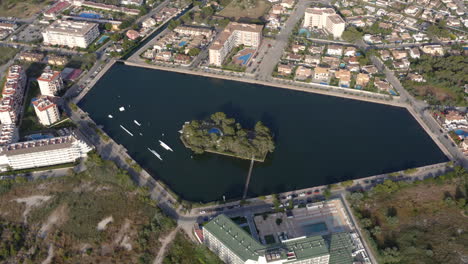 Big-water-pond-in-shape-of-pentagon-in-residential-city-area,-Alcudia