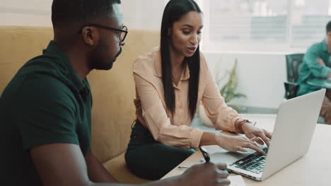 Two-young-business-people-sitting-in-the-office