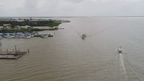 Moving-aerial-shot-around-boat-on-an-amazonian-river-in-Belem,-Para,-Brazil