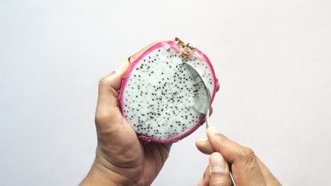 Top-view-of-men-eating-a-dragon-fruit