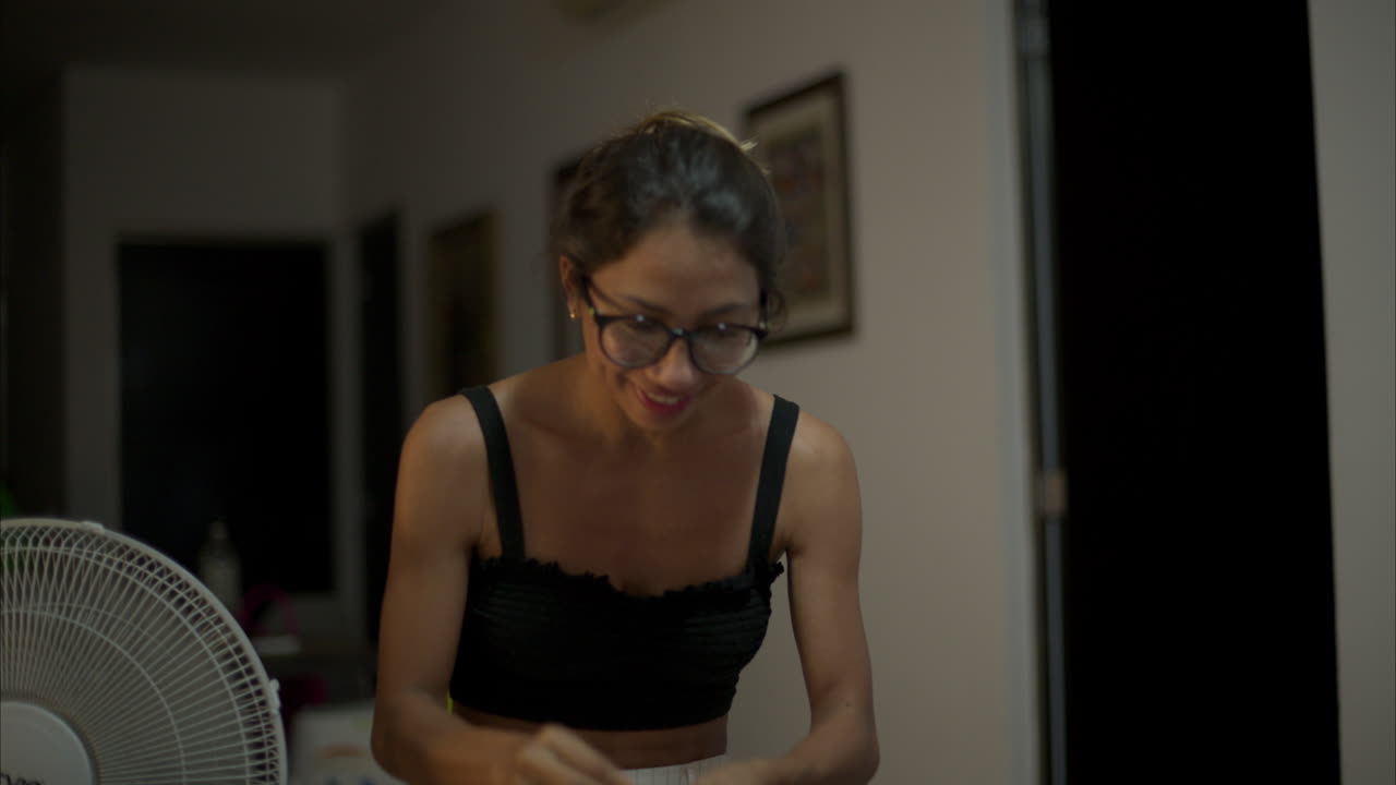 Slow motion of a latin thin woman with glasses playing a game with friends acting as if she was eating something and then as flying