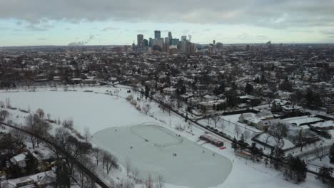 Aerial-View-of-People-Skating-on-Frozen-Pond