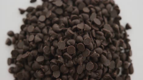 Video-of-close-up-of-multiple-chocolate-chip-over-white-background