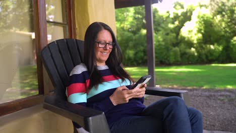 A-Woman-Relaxing-While-Interacting-With-Her-Mobile-Device---Close-Up