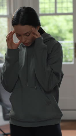 vertical video of anxious woman at home comfort eating snack before sitting indoors on sofa and working on laptop 1