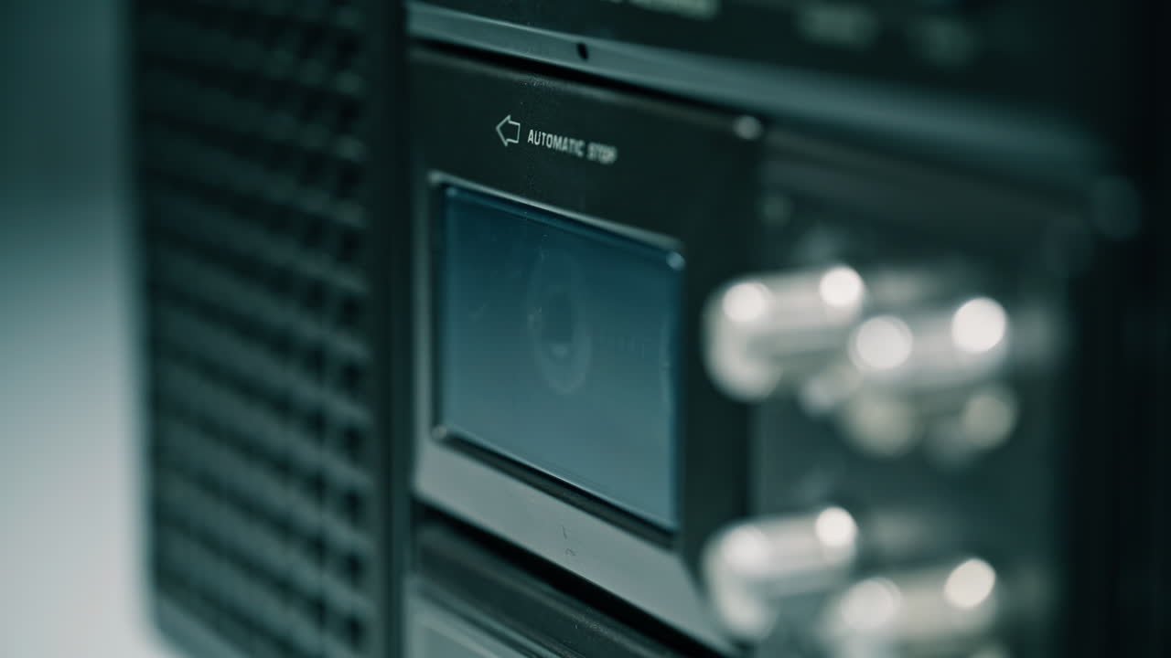 Macro radio player open deck door. Man fingers putting music cassette inside