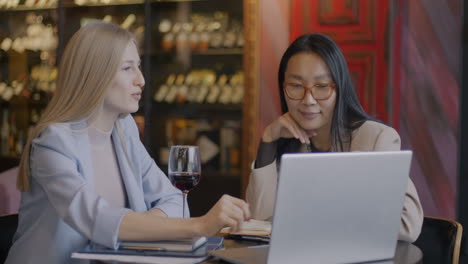 Businesswomen in discussion at a restaurant