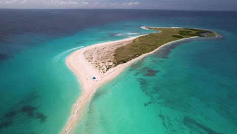 People-walk-on-tropical-sandbar,-drone-movement-backwards-descent,-Cayo-de-agua-Los-Roques