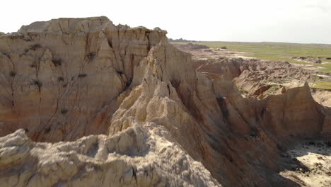 drone aerial view of steep sandstone cliffs and other rock formations, badlands national park, south dakota usa