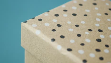 close-up of a brown gift box with polka dots