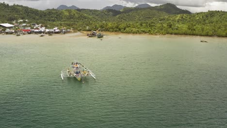 orbital view of fishing trawlers off the coast of the philippines with landscape hills near surigao