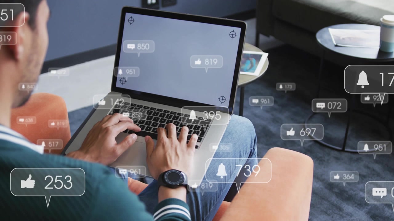 Man Using Laptop with Social Media Notification Overlays