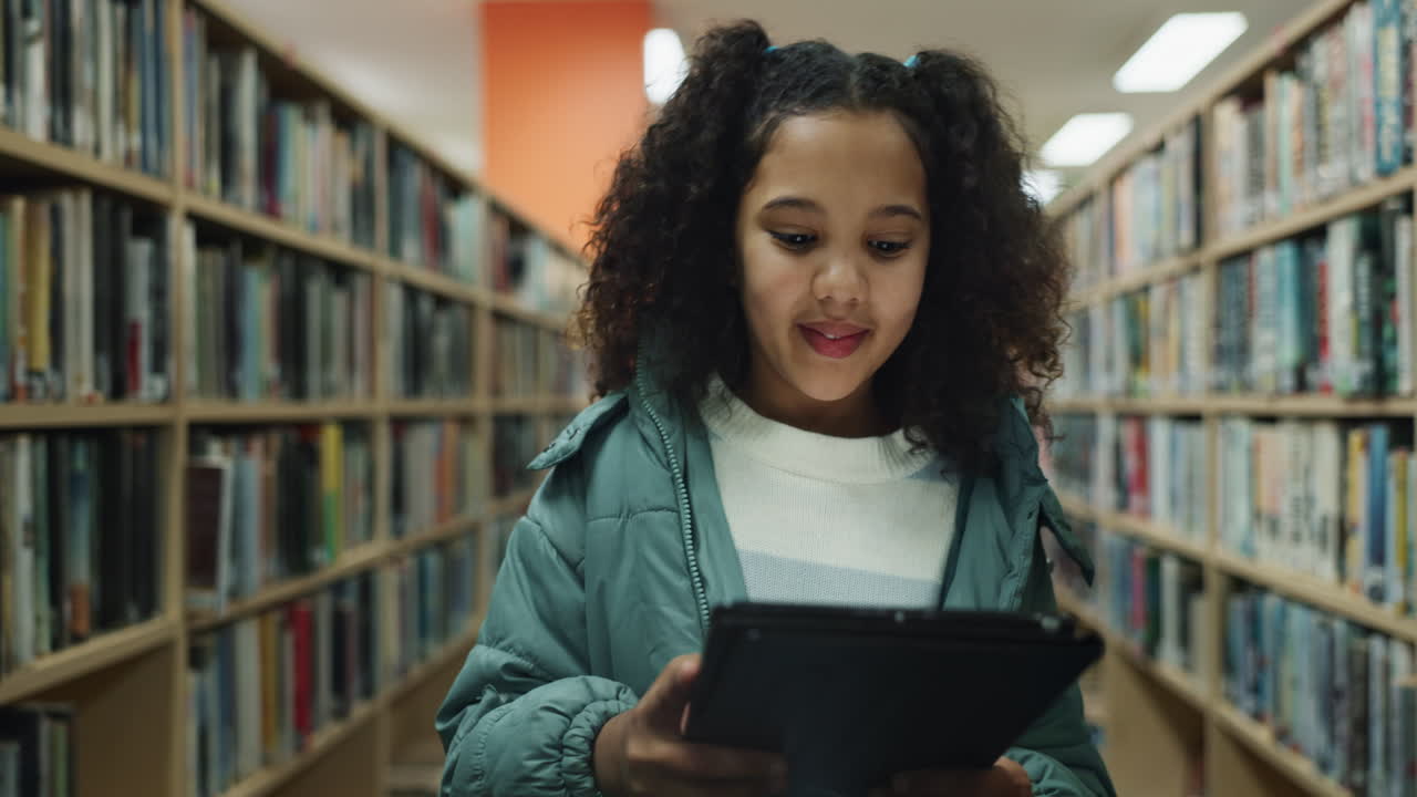 Girl using tablet in library