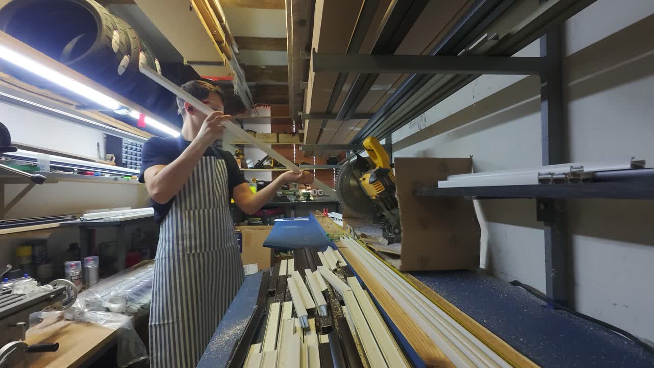 A man working with a circular saw in a workshop