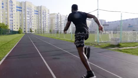 man running on a track in the city