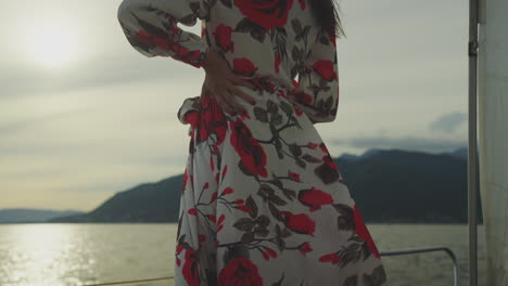 woman in a floral dress on a sailboat