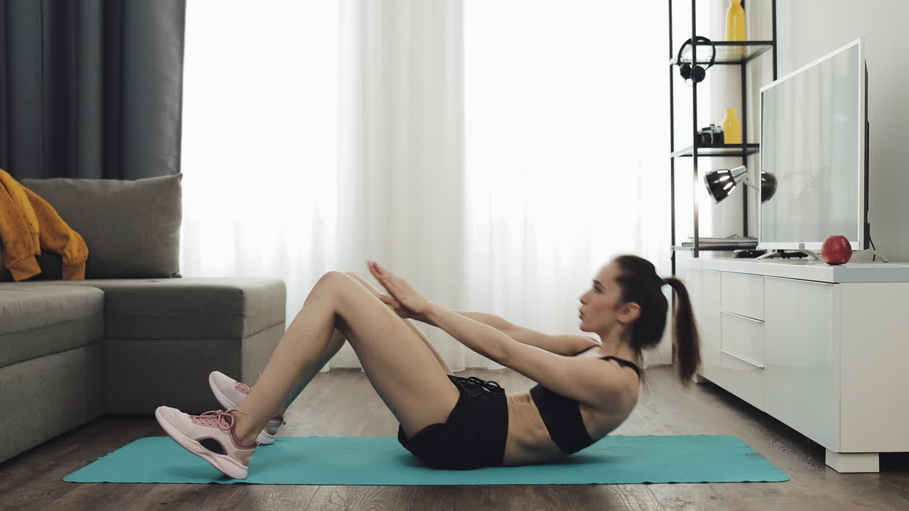 Woman doing sit-ups at home