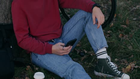 man relaxing in park with phone