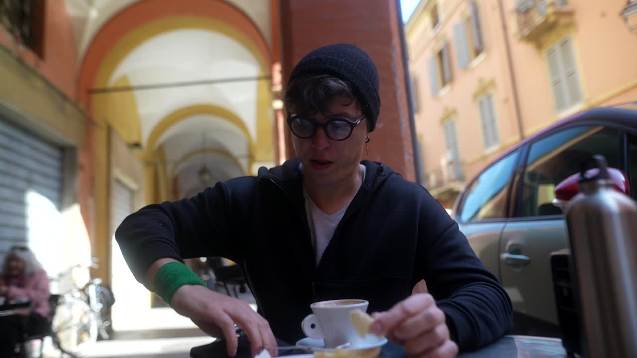Man enjoying a coffee and pastry in a European city