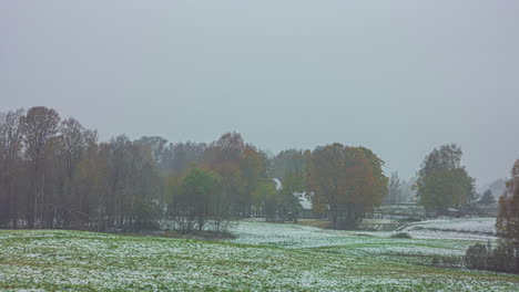 time-lapse of a vibrant, sunny, fall day turning to a snowstorm landscape