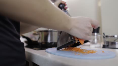 Carrots-on-a-grater-rubbed-on-the-home-kitchen.-Cutting-Carrot-Grater