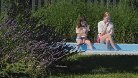 girls relaxing by the pool