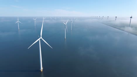 huge windmill turbines, offshore windmill farm in the ocean westermeerwind park , windmills isolated at sea on a beautiful bright day netherlands flevoland noordoostpolder