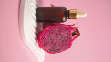 dragon fruit skincare serum on pink background