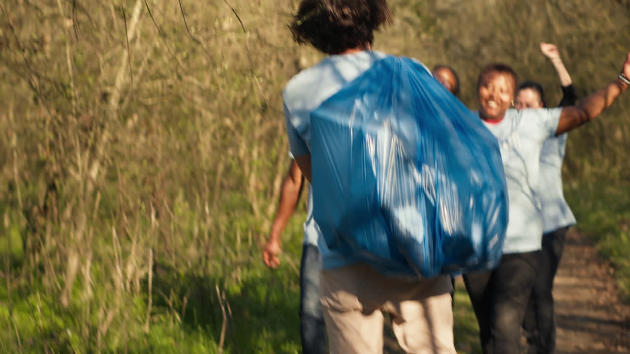 Satisfied people leaving the woods after a productive litter cleanup session