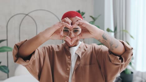 young cheerful cute african american woman making heart symbol with fingers