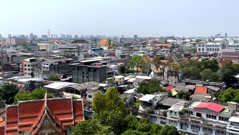 establishing panning shot across downtown bangkok traditional and modern mixed cityscape properties, thailand