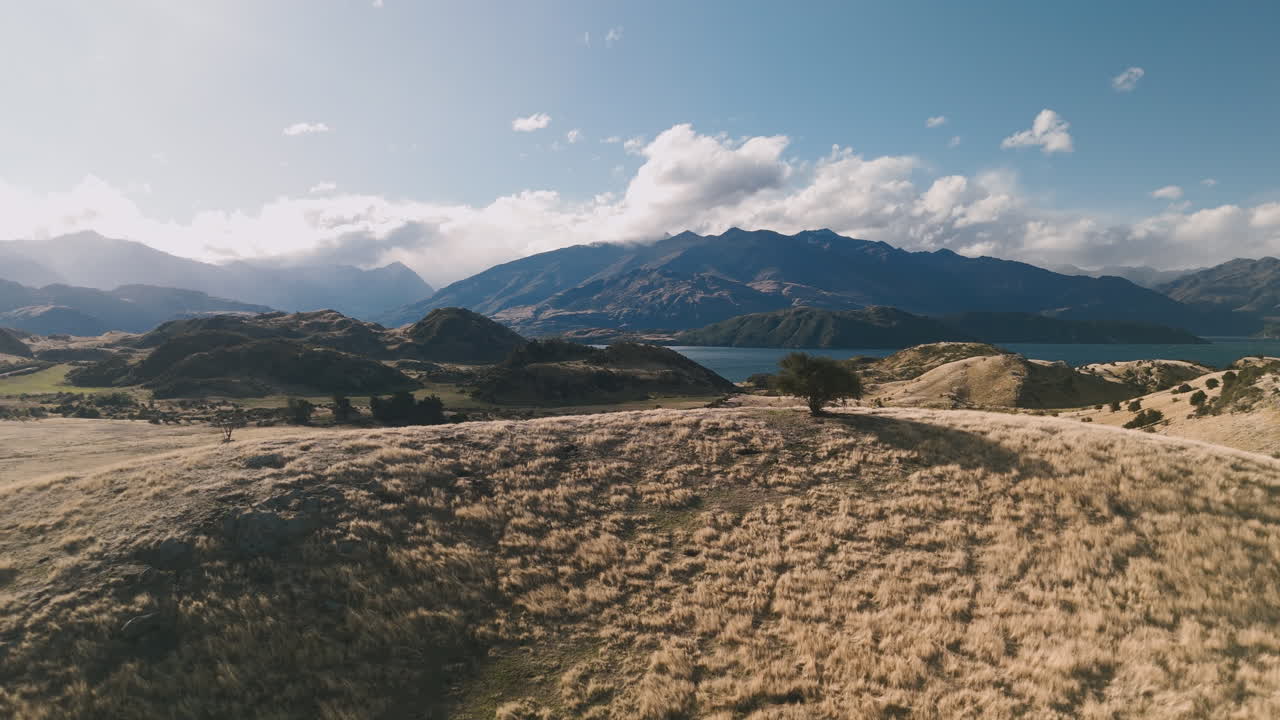 Mountainous Landscape with Lake and Rolling Hills