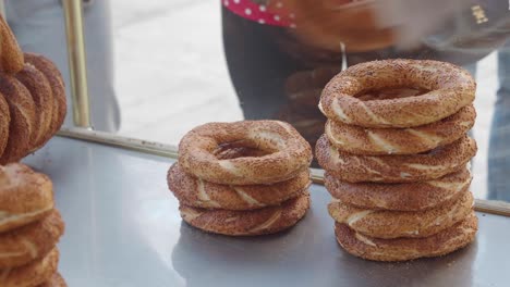 stacks of simit turkish bread on display at a food stall
