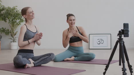 two female yogi shooting yoga lesson on video