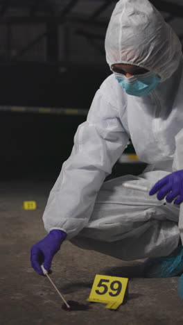 a crime scene investigator collects evidence at a crime scene