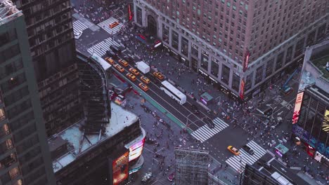nyc: times square from above closeup shot of traffic, pedestrians, intersections, billboards and neon lights, looking at the base of the paramount building - new york city, usa