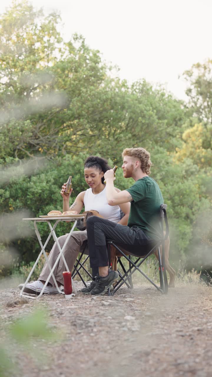 Couple enjoying a picnic with their dog outdoors