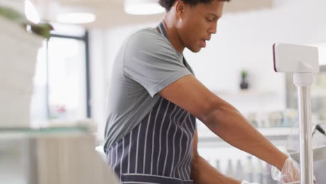 animation of midsection of focused biracial waiter weighting cheese